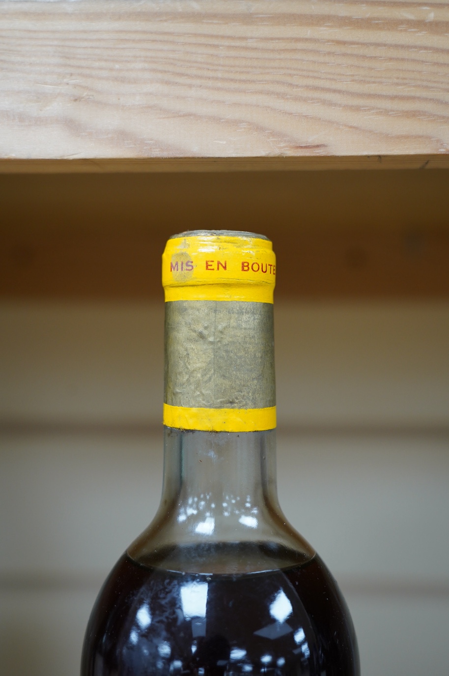 A bottle of Chateau d'Yquem, 1969. Condition - fair, level just above mid shoulder, label poor